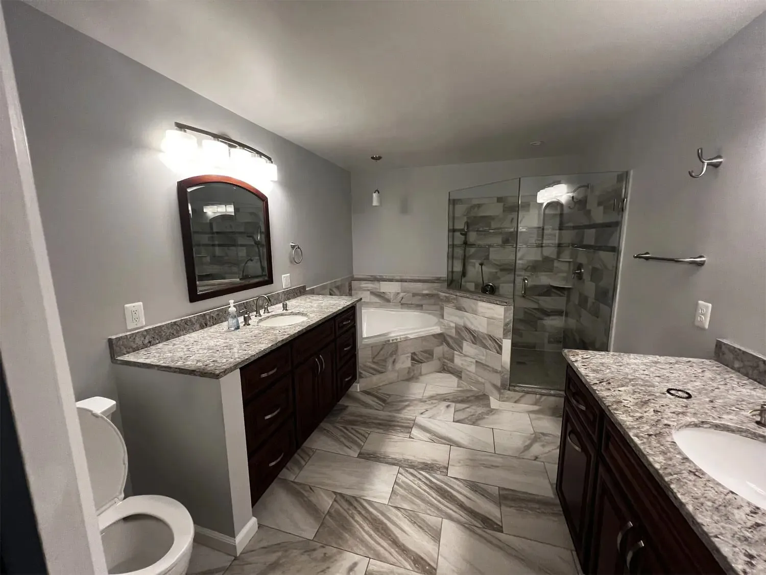 A bathroom tile installation in Baltimore, MD showcasing elegant ceramic wall and floor tiles.