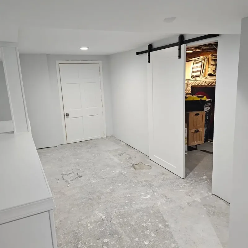 Finished basement with new barn door and storage room in Arnold, MD