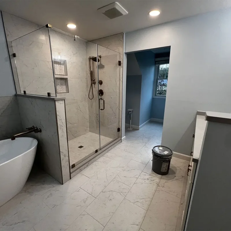 Freestanding bathtub next to a glass shower in a remodeled Columbia, MD bathroom