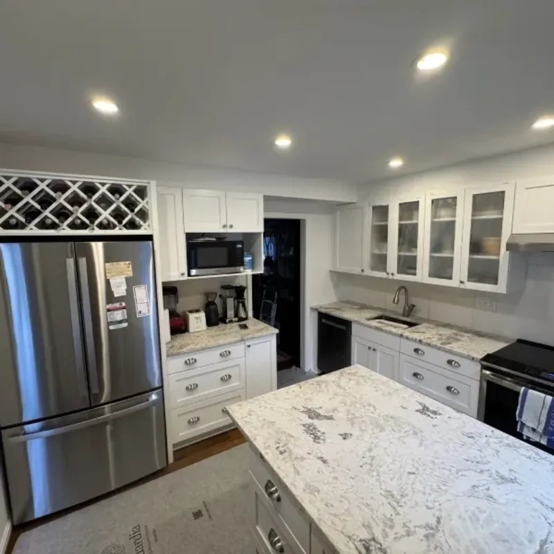 Remodeled kitchen with white cabinets, quartz island, and stainless appliances in Arnold, MD