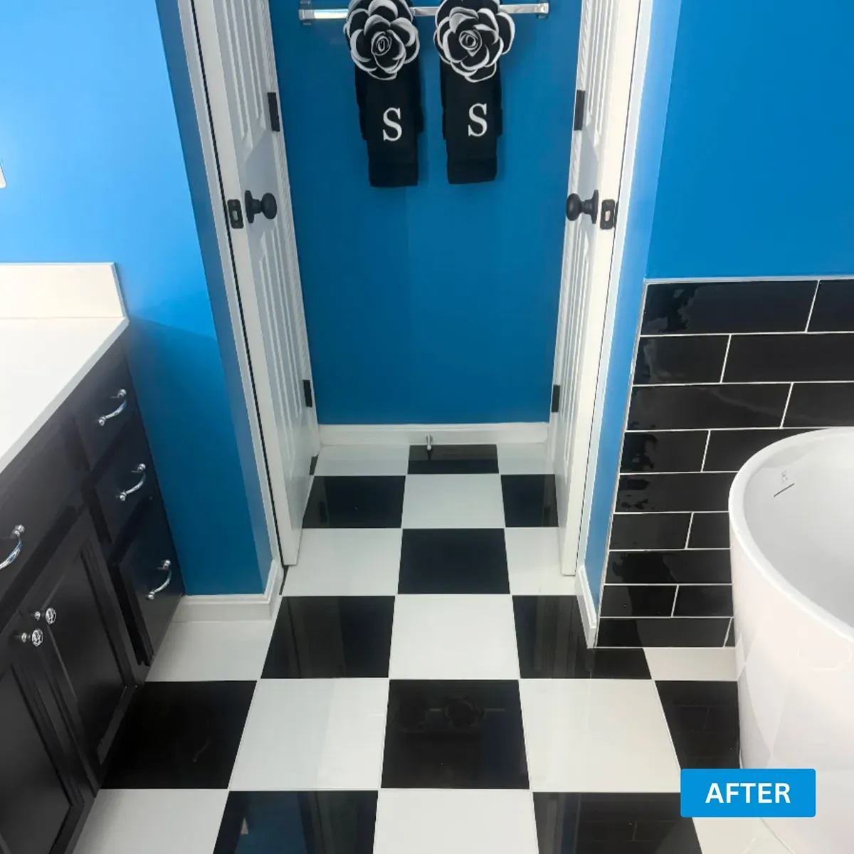 Finished black and white checkerboard tile floor in a remodeled bathroom
