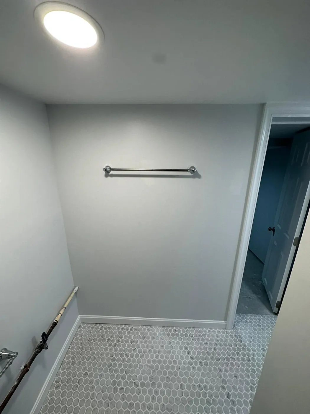 White hex mosaic bathroom flooring meeting the trim, Gambrills bathroom flooring