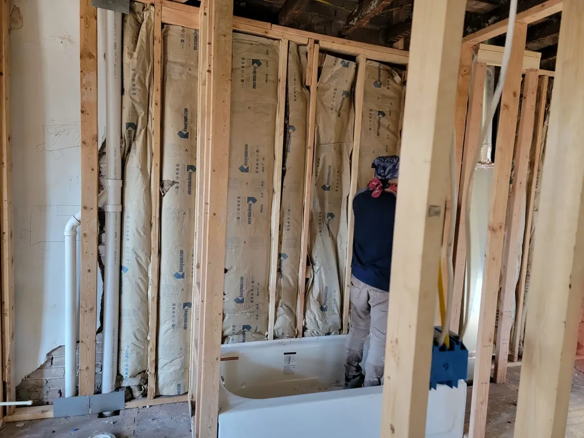 Global Remodeling Pros team member working inside a framed bathroom before tile goes up