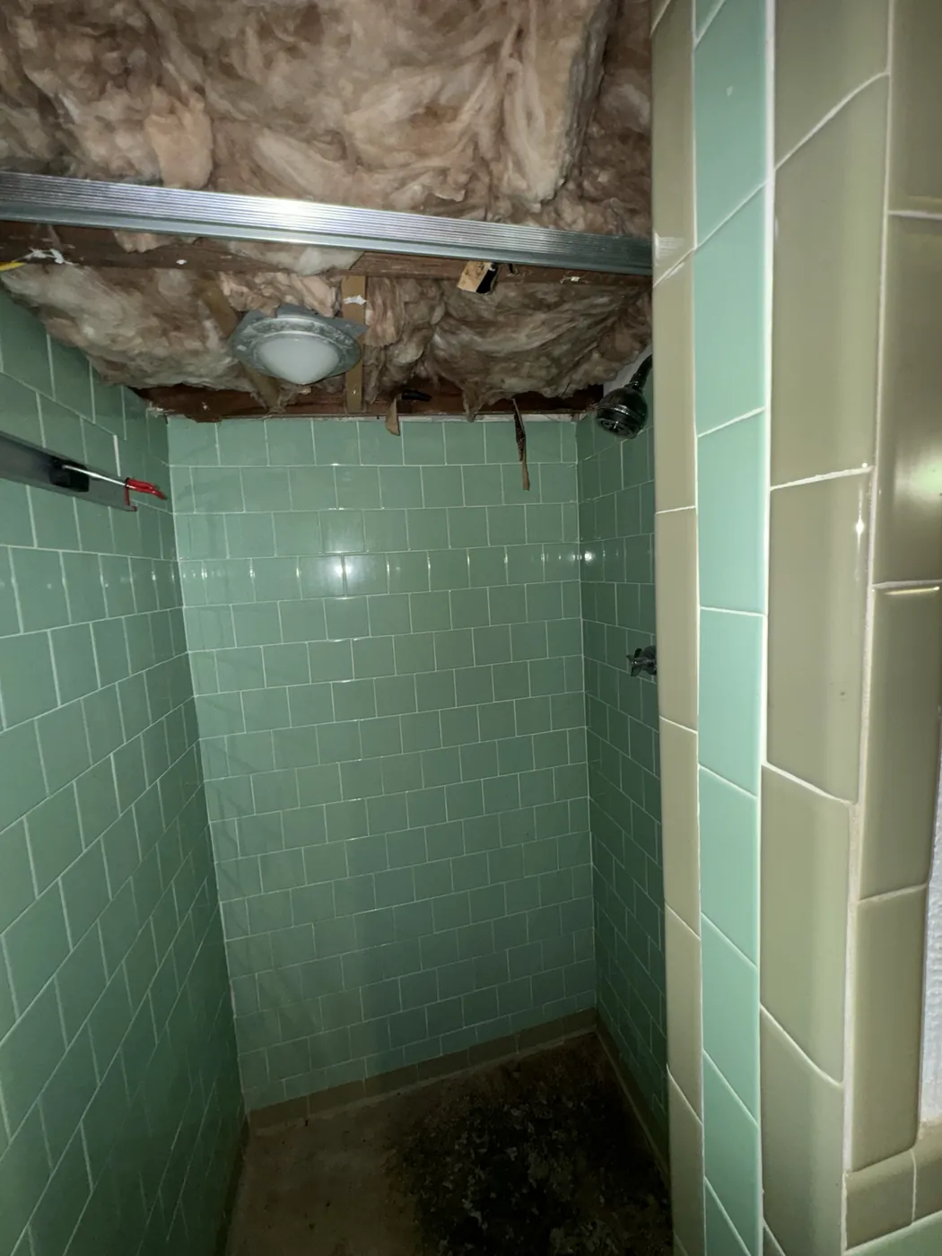 Older green wall tile in a shower before tile replacement, Gambrills bathroom tile work