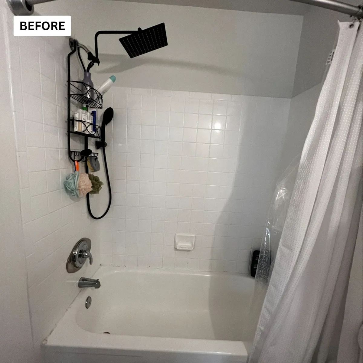 Worn tub and tile surround with a crowded shower caddy before a bathroom renovation