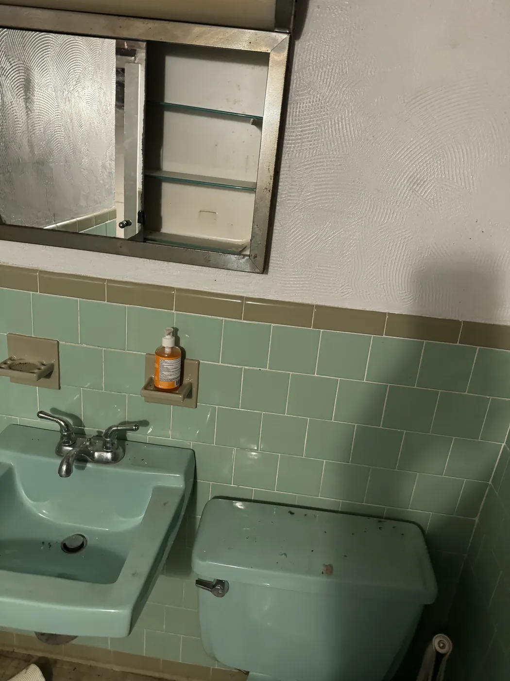Older wall-hung sink and toilet before fixture replacement, Gambrills toilet and sink work