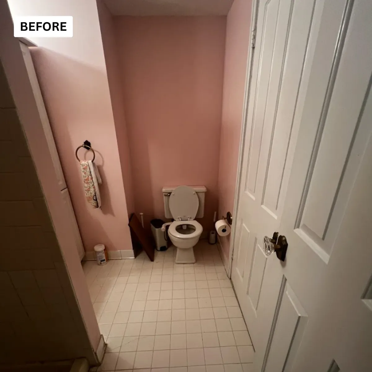 Dated powder room with pink walls and an old toilet before replacement