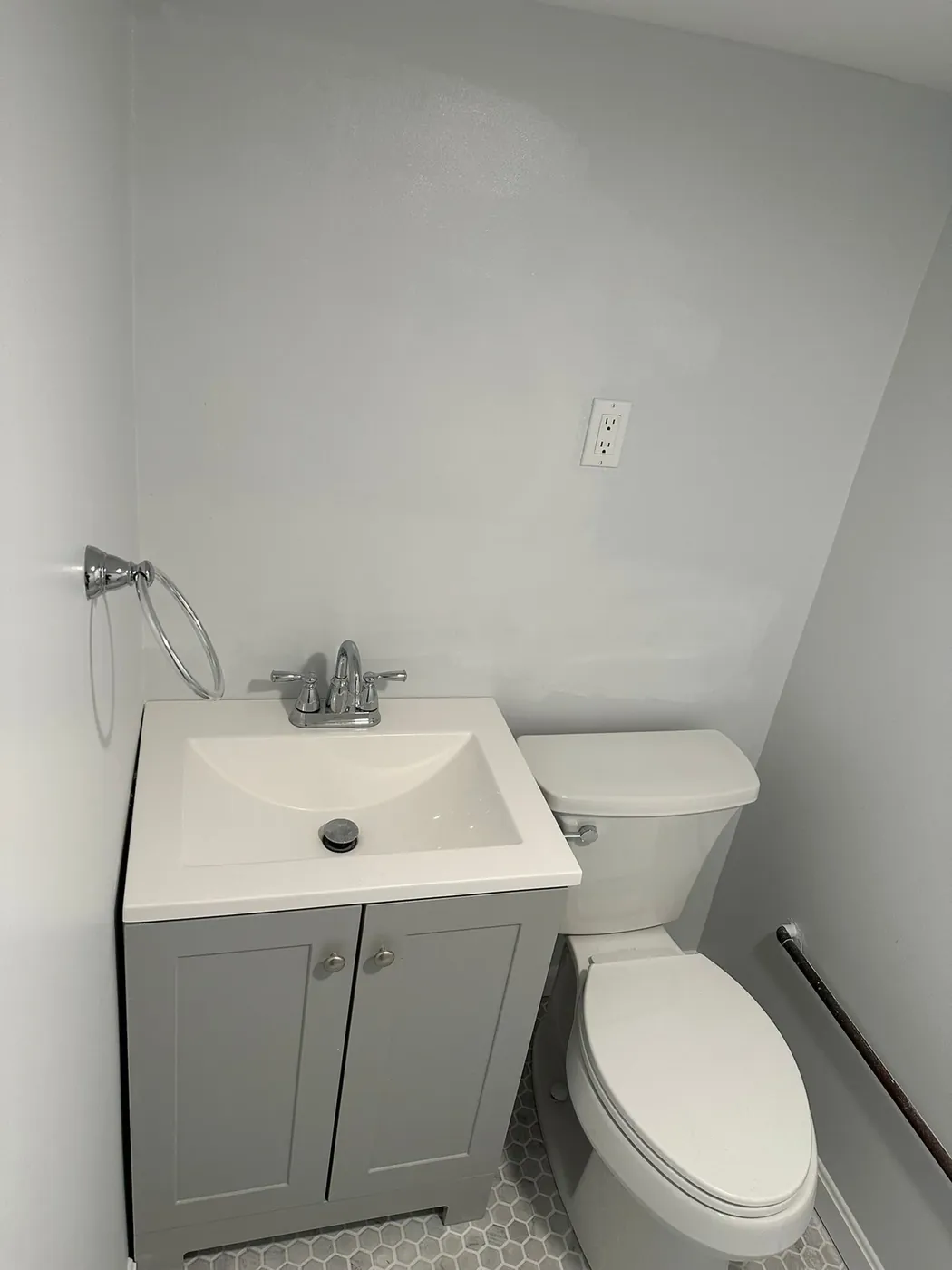 Compact gray single-sink vanity beside a toilet, Gambrills vanity and cabinet installation