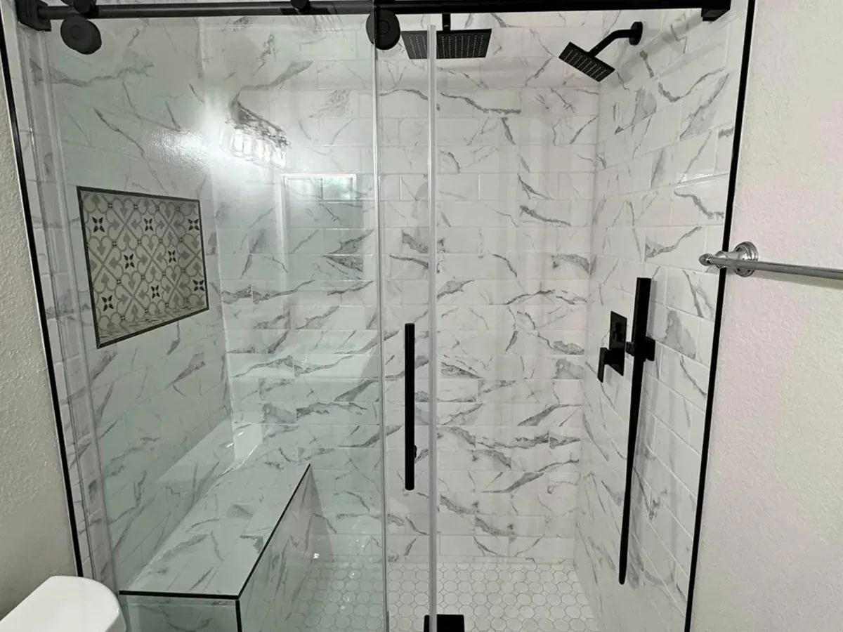 Tiled shower with a built in bench and low threshold entry after an accessible bathroom remodel in Arnold MD