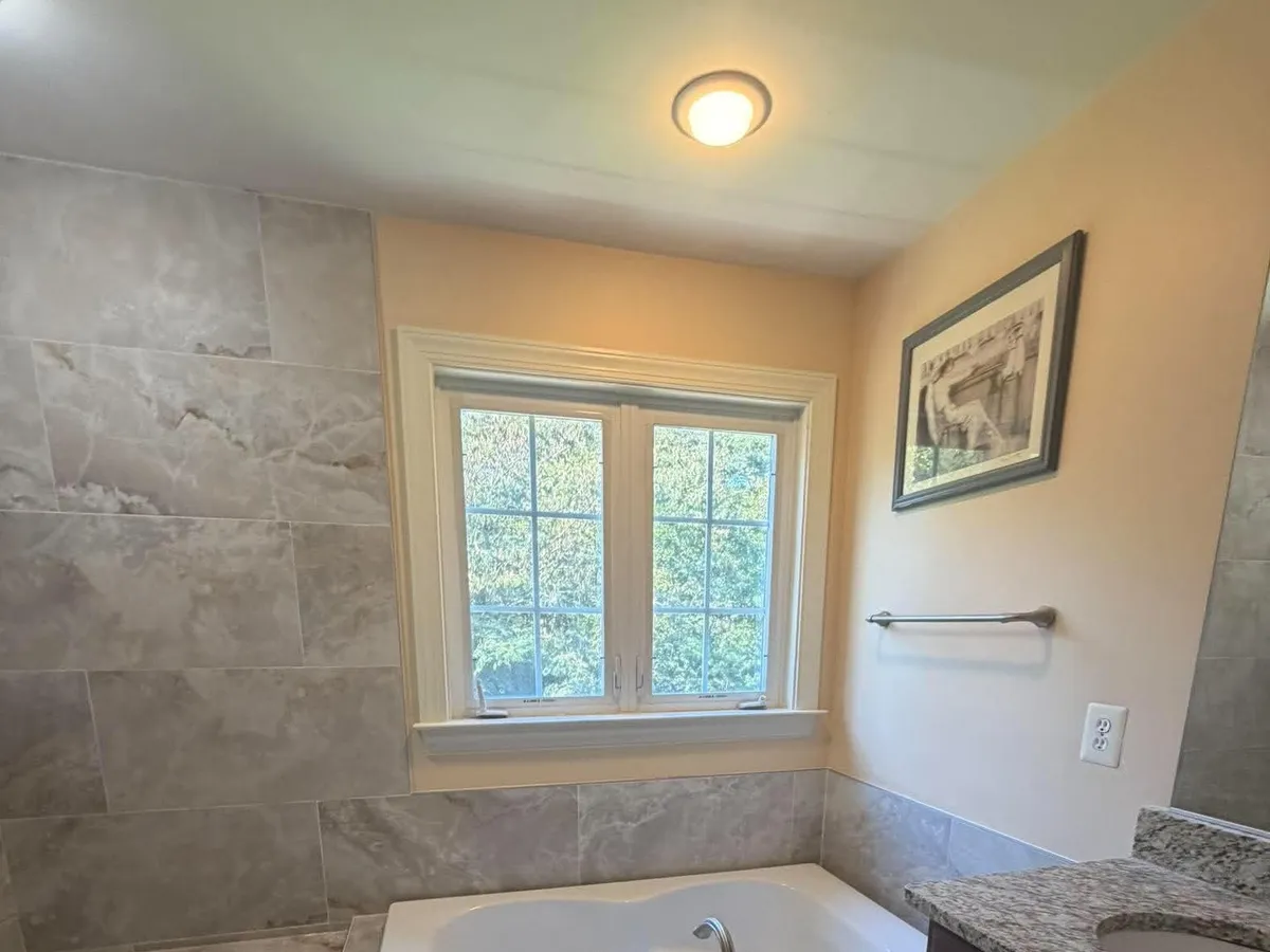 Flush ceiling light above the tub area of a finished Pasadena, MD bathroom