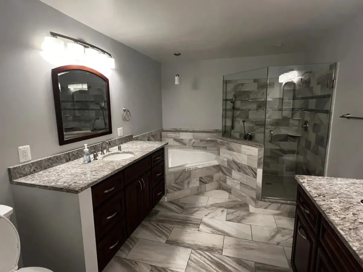 Primary Pasadena MD bathroom with a glass shower beside a garden tub and a granite vanity