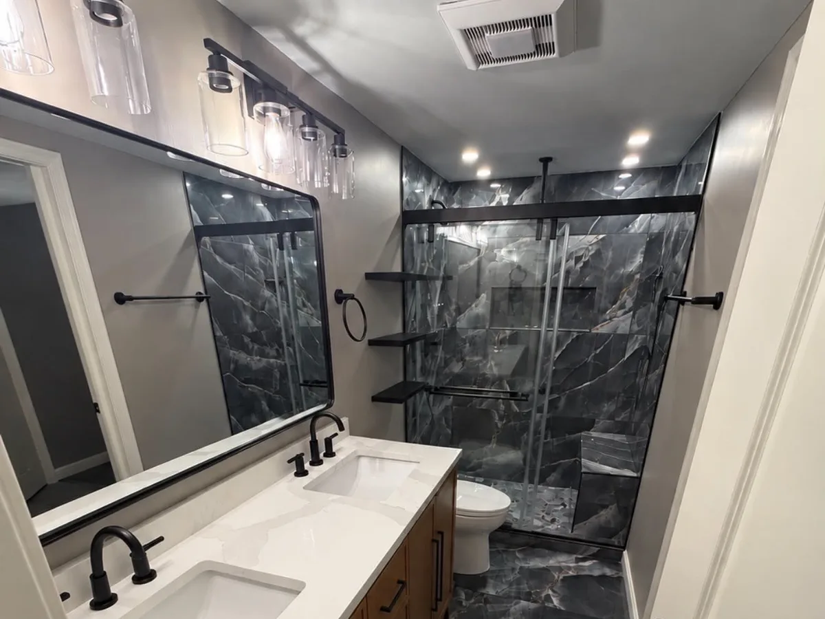 Double vanity with a quartz top and black marble floor tile in an Arnold MD master bathroom
