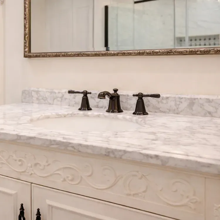 Stone vanity top with an undermount sink and widespread faucet in an Arnold MD bathroom