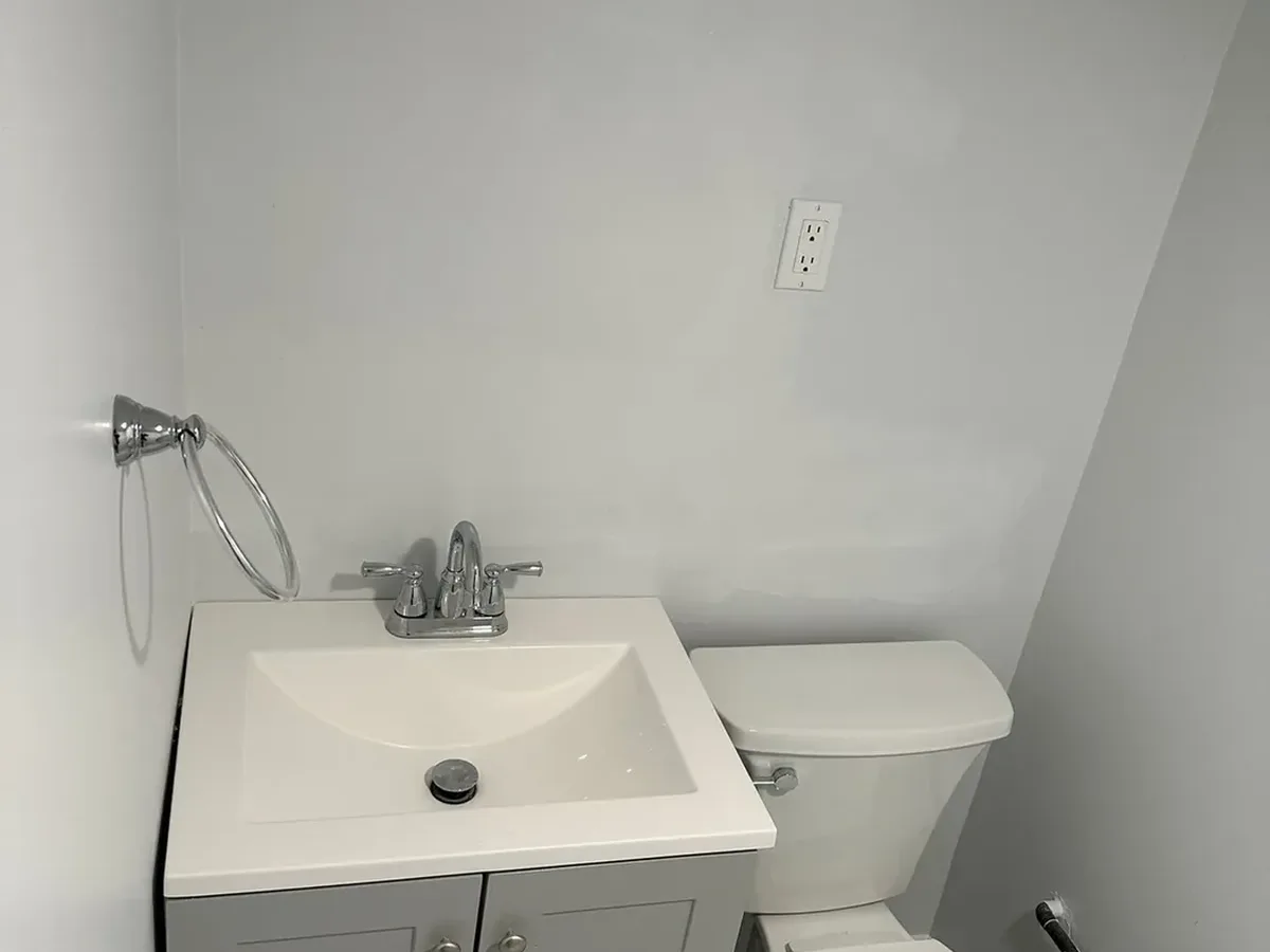 Compact vanity and toilet in a finished small bathroom remodel in Arnold, MD