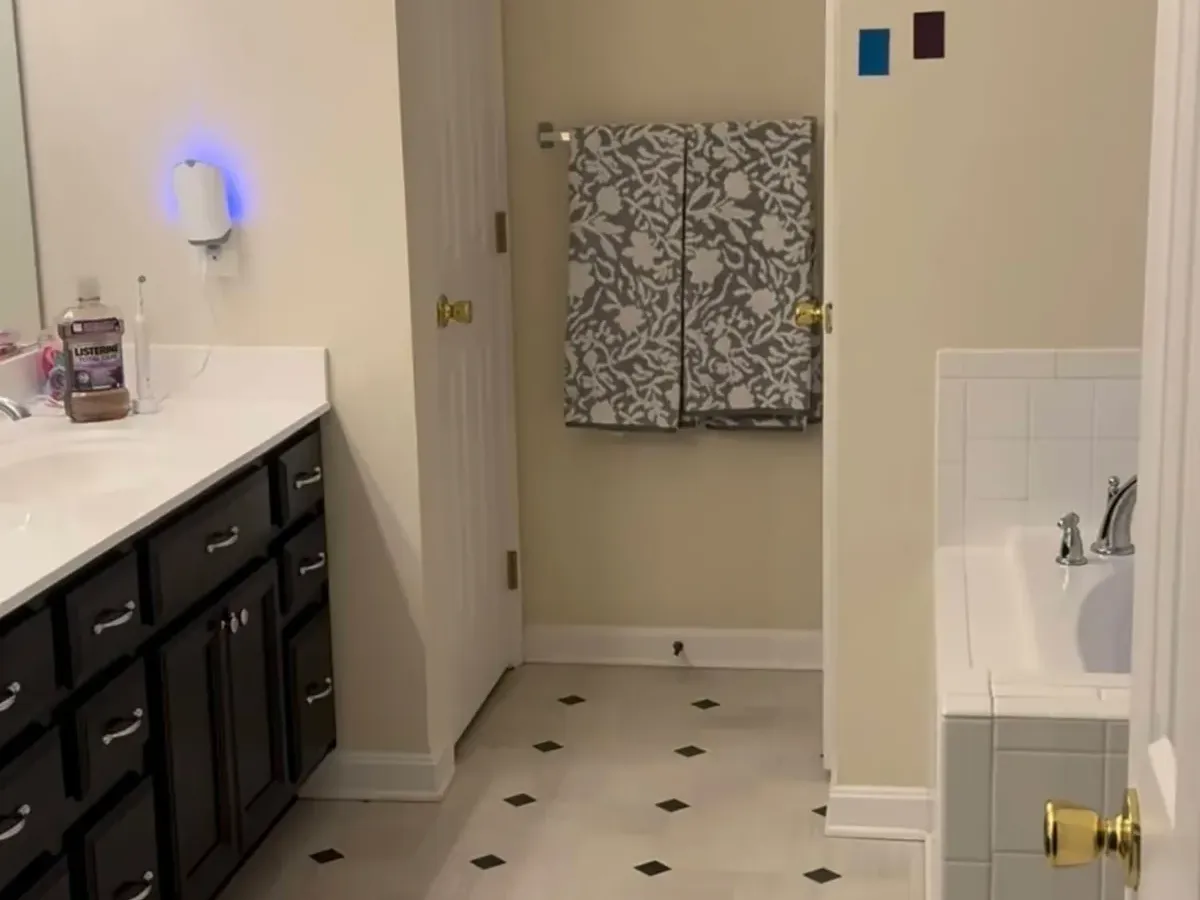 Dated Columbia, MD hall bath before a small bathroom remodel, with a dark vanity and a worn tub alcove